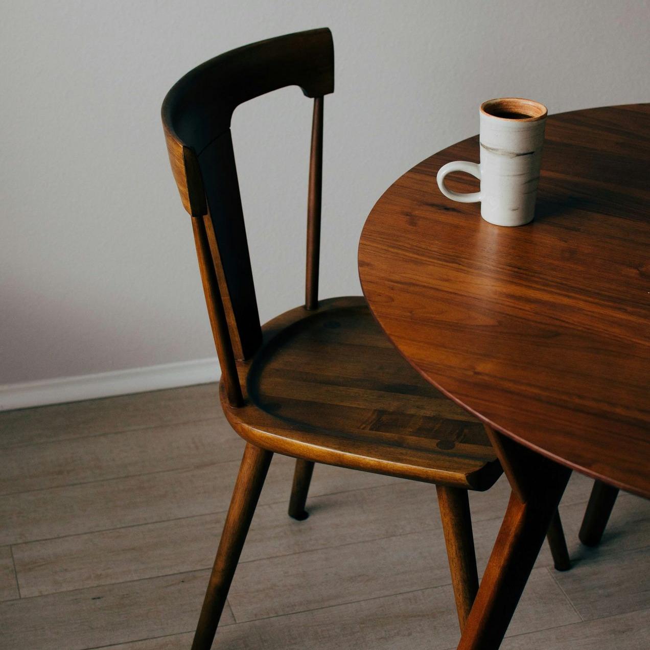 white ceramic mug on brown wooden table